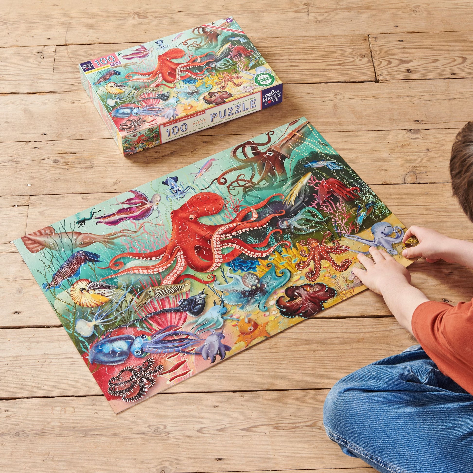 Child assembling Illustration of various sea creatures including an octopus on a colorful underwater background.