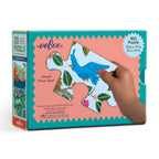 eeBoo puzzle box with a hand holding a piece. Garden Animals 20 Piece Puzzle by eeBoo | Unique Fun Gifts
