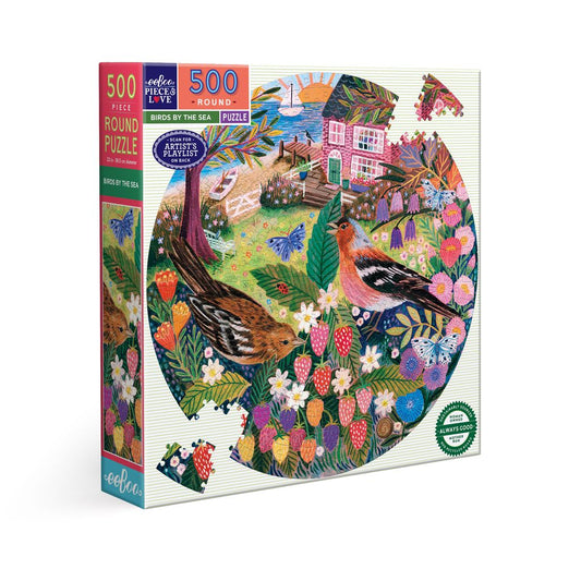 Round puzzle box with colorful artwork of birds and nature, featuring ' eeBoo'. Birds by the Sea 500 Piece Round Puzzle