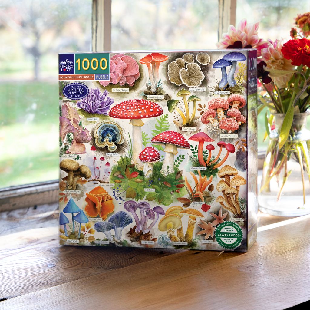 Jigsaw puzzle box with mushroom design on a wooden surface. Bountiful Mushrooms 1000 Piece Puzzle