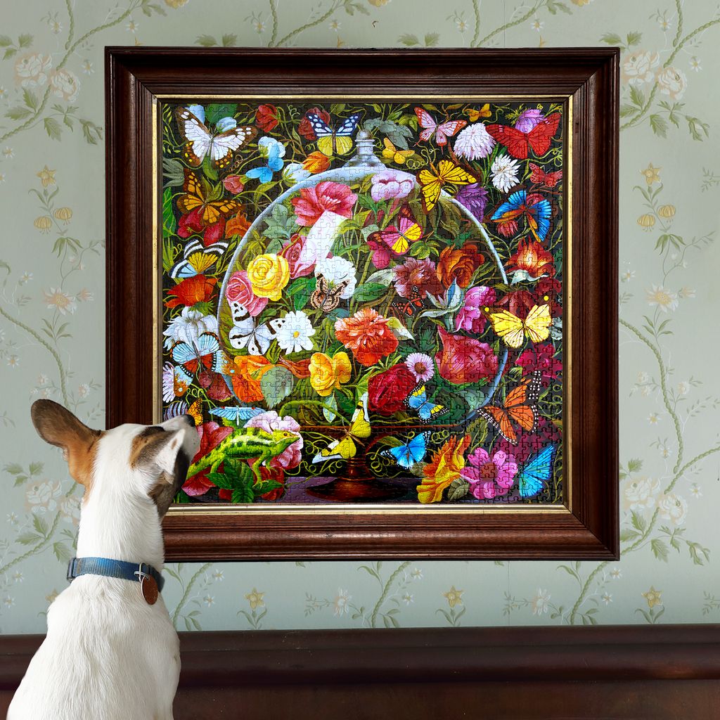 Dog looking at a colorful stained glass artwork of flowers and butterflies on a wall.