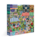 Artist Vanessa Bowman depicts a festive village square filled with tents, crafts & a colorful crowd gathering for the country fair. 1000 Piece Jigsaw Puzzle by eeBoo 