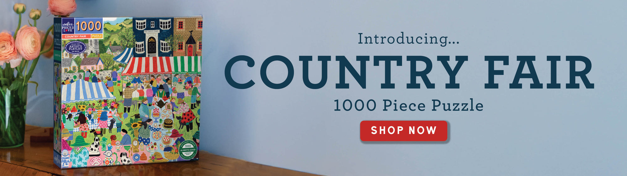 Jigsaw puzzle box for 'Country Fair' puzzle on a wooden surface with a blue background.