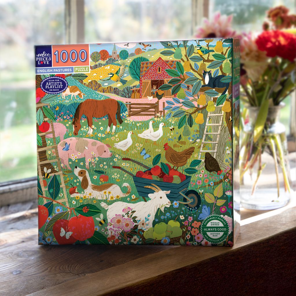 Jigsaw puzzle box with farm scene design on a wooden surface
