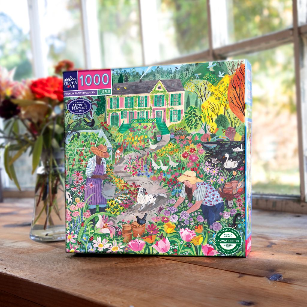 Jigsaw puzzle box with a colorful garden scene on a wooden table