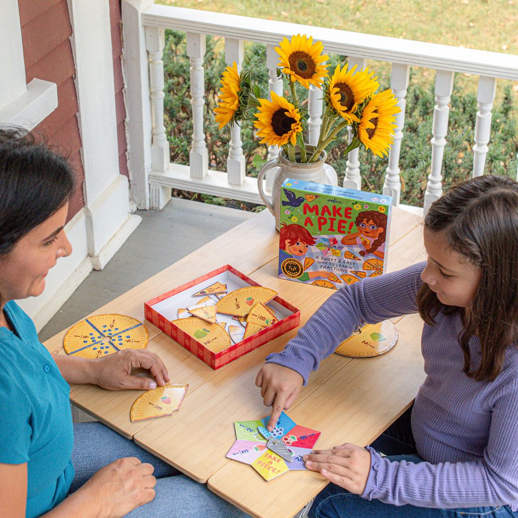 Two people playing a puzzle game on a porch with sunflowers in the background