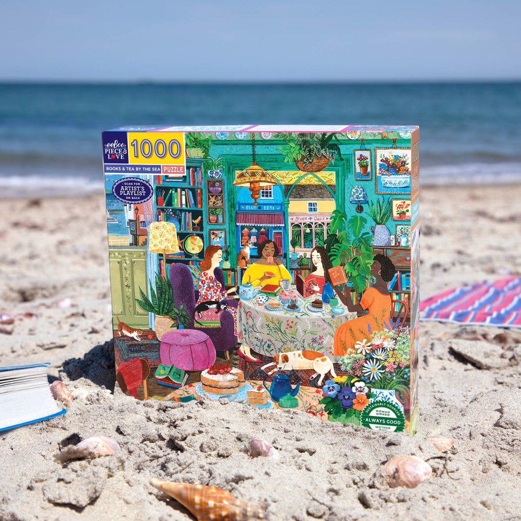 Painter Stephanie Lambourne depicts a cozy seaside women's reading group sharing ideas, tea, books, plants, & a playful cat. 1000 Piece Jigsaw Puzzle by eeBoo 