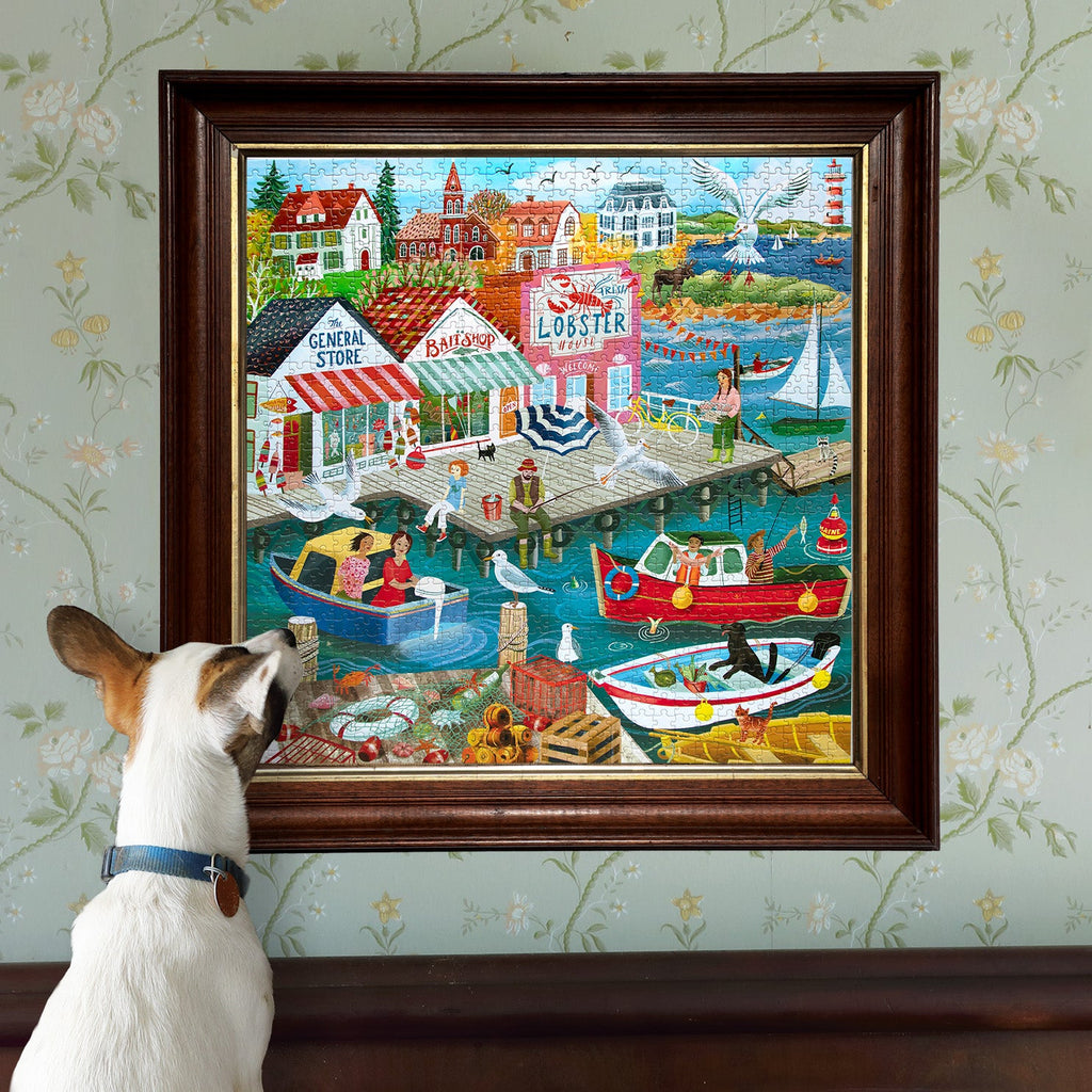 Illustrator Uta Krogmann depicts a classic New England harbor town with colorful buoys, fishing boats, a lighthouse, & lobster traps. 1000 Piece Jigsaw Puzzle by eeBoo 