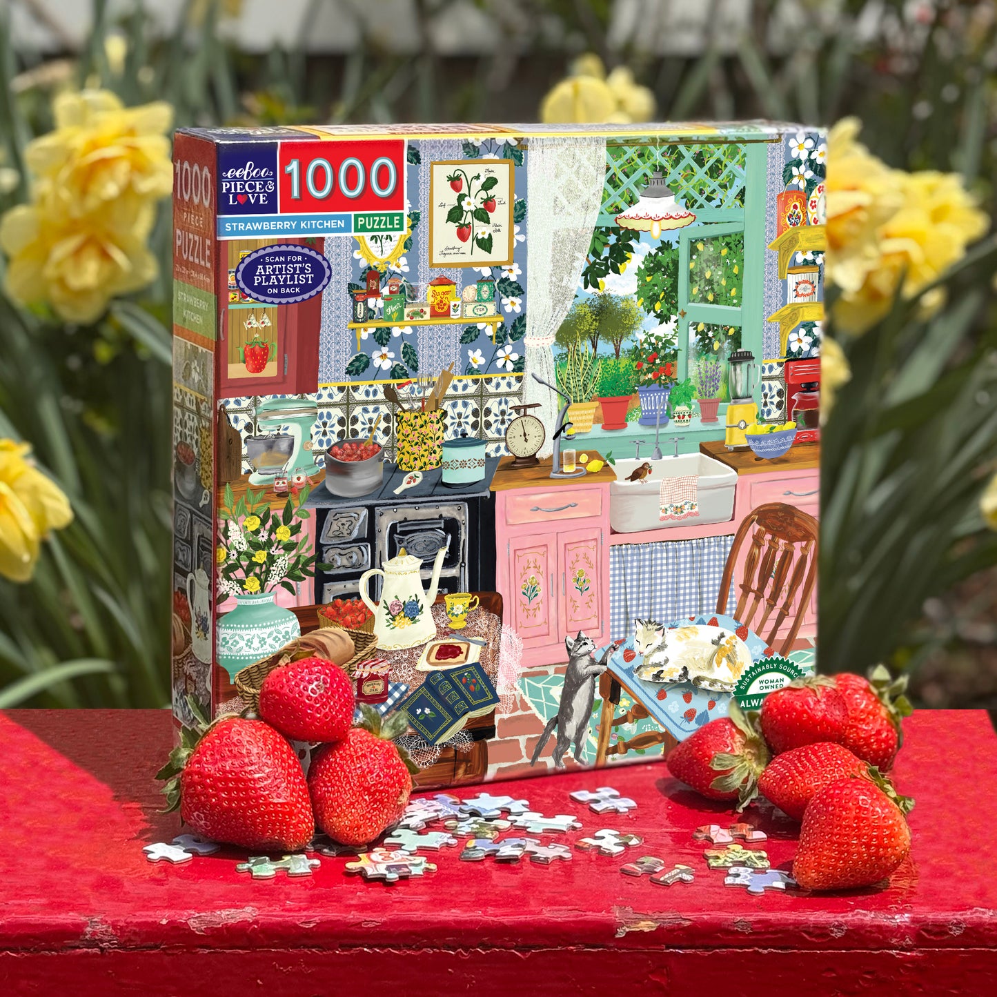 Jigsaw puzzle box with strawberry kitchen theme on a red surface with fresh strawberries