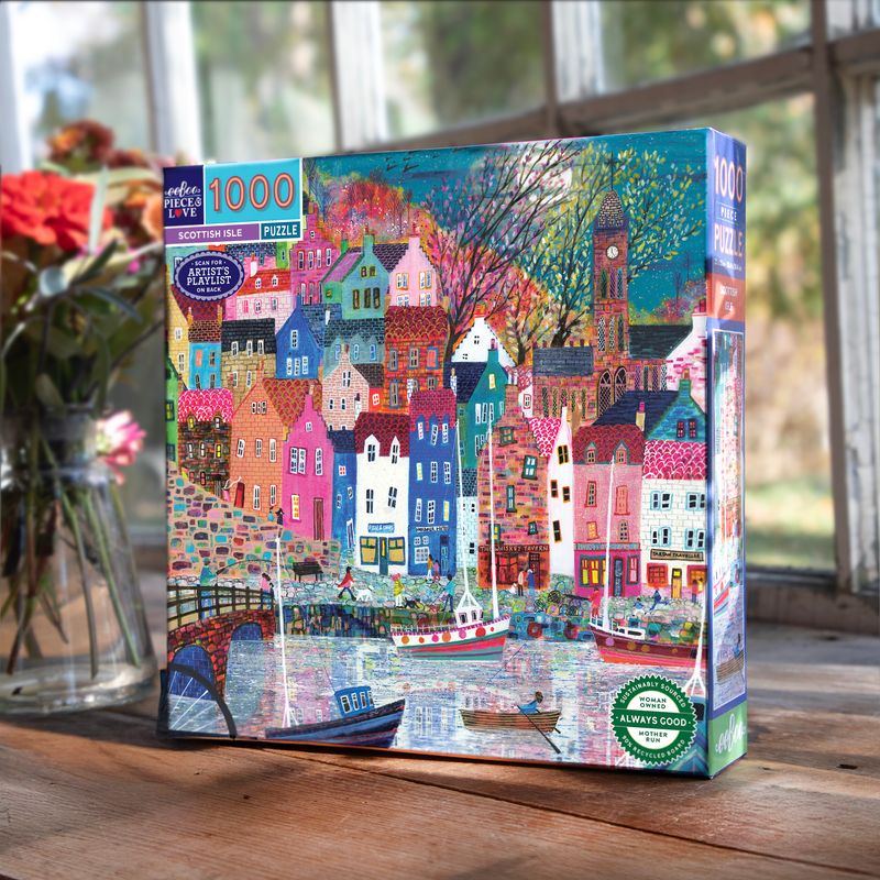 Jigsaw puzzle box with colorful village design on a wooden surface