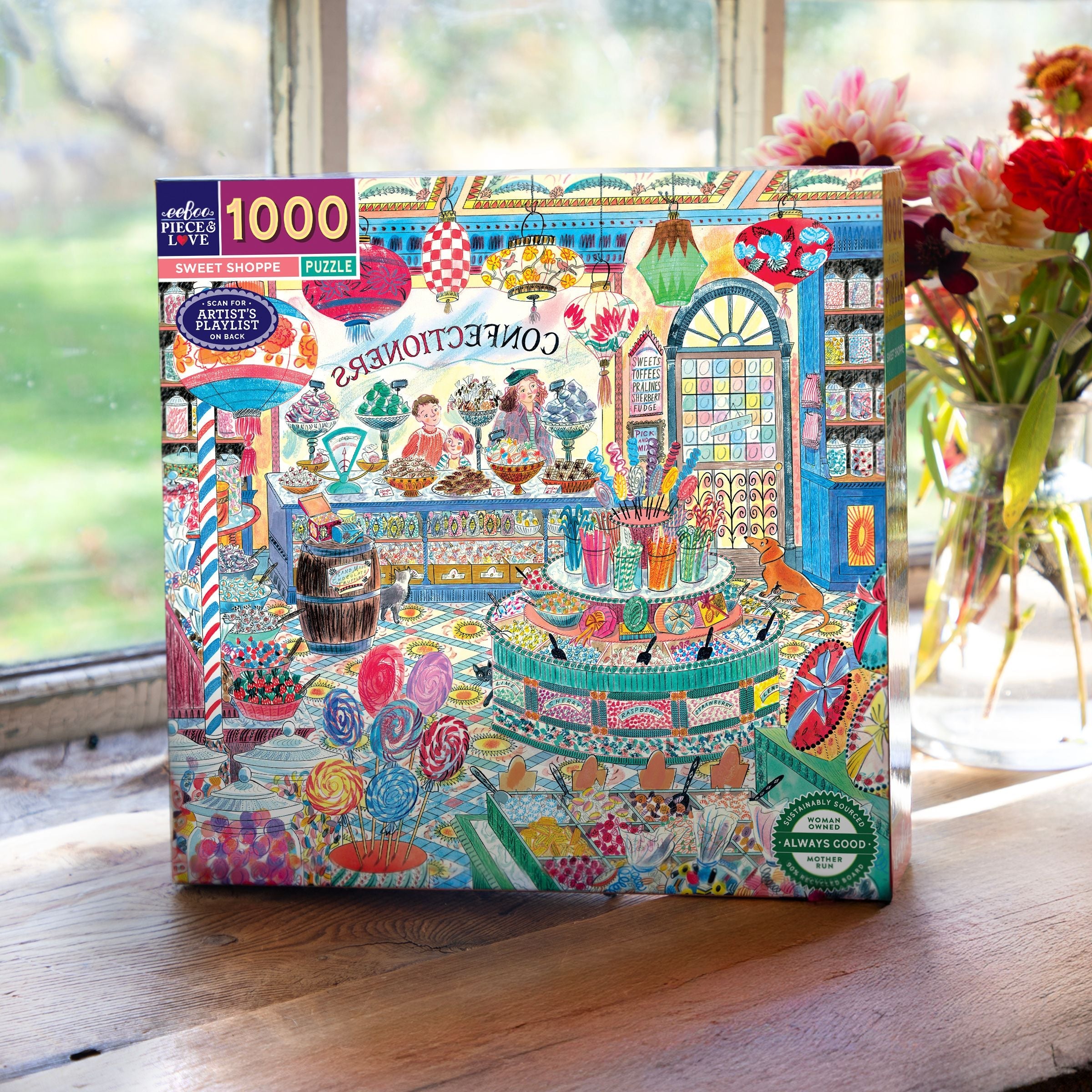 Jigsaw puzzle box with colorful design of a candy shop on a wooden surface.