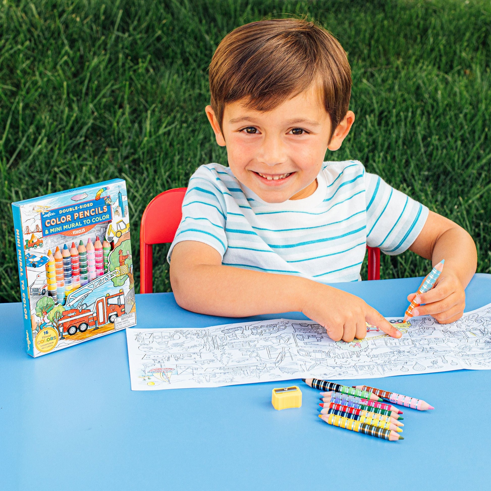 Child coloring with color pencils outdoors on a grassy background. Vehicles Mini Mural Bundle 