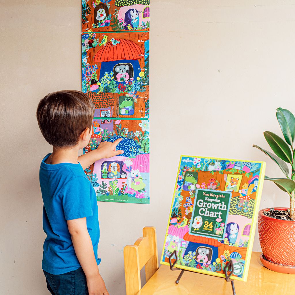 Child looking at a colorful growth chart. Yumi Growth Chart