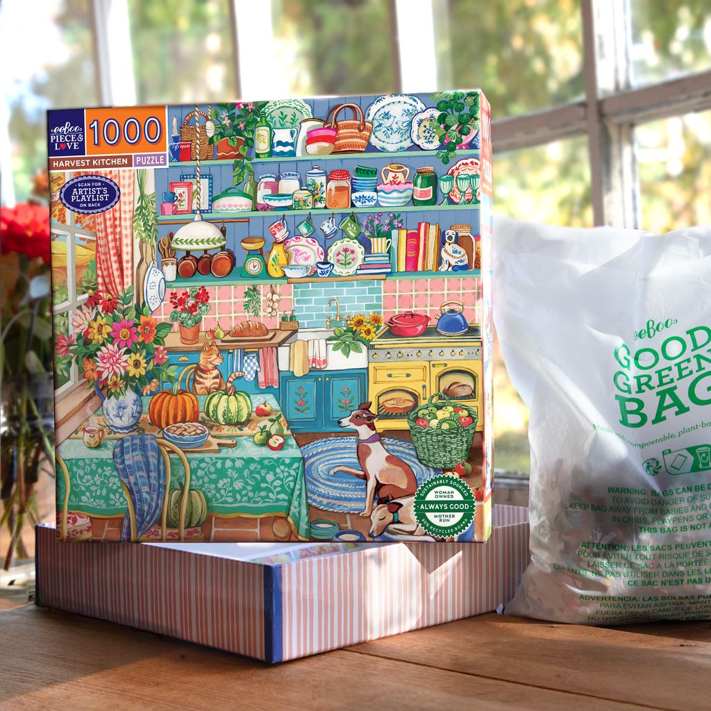 Jigsaw puzzle box featuring a colorful kitchen scene with  cat and a dog. Harvest Kitchen 1000 Piece Puzzle
