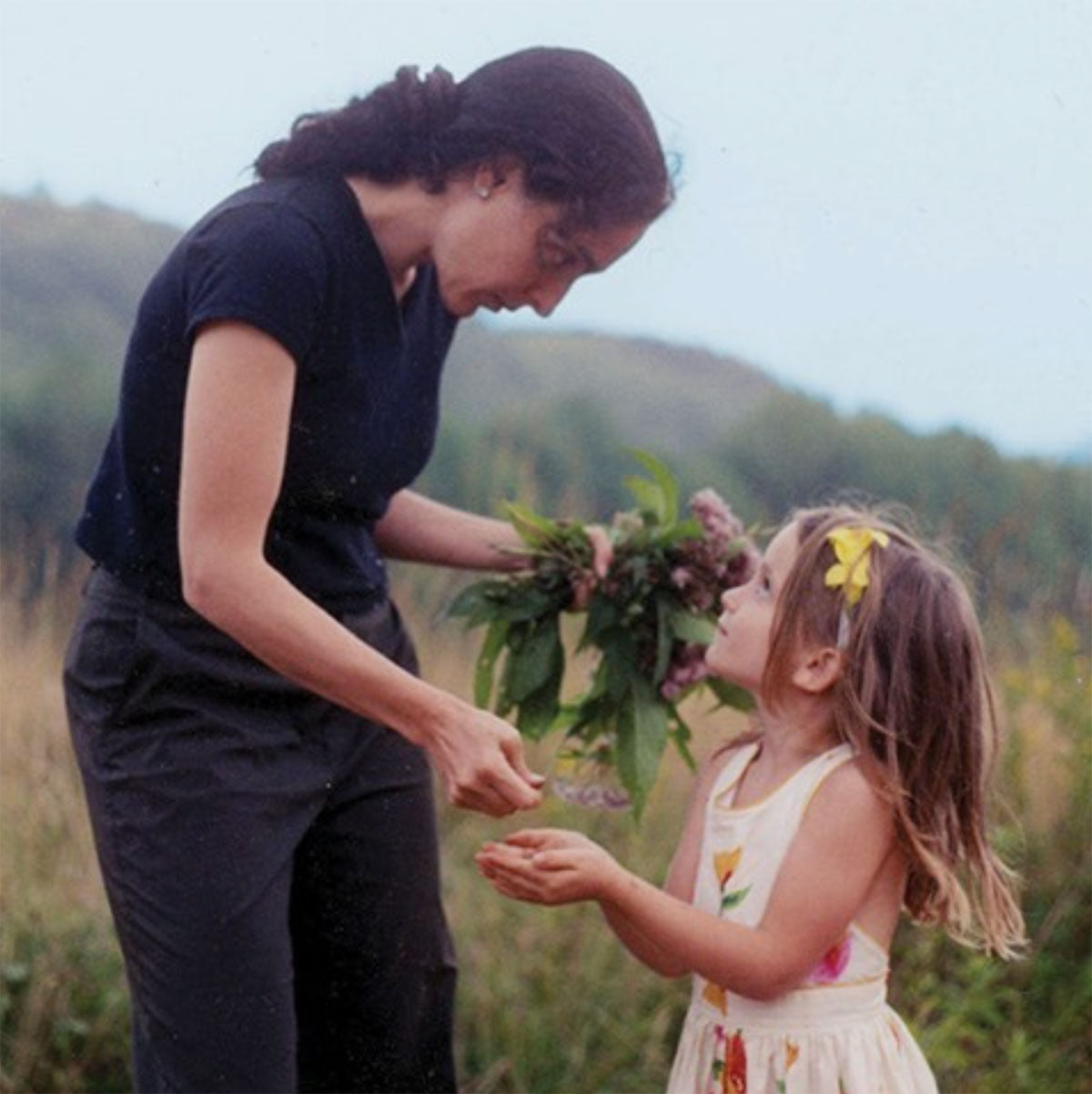 Mia and her daughter in a field