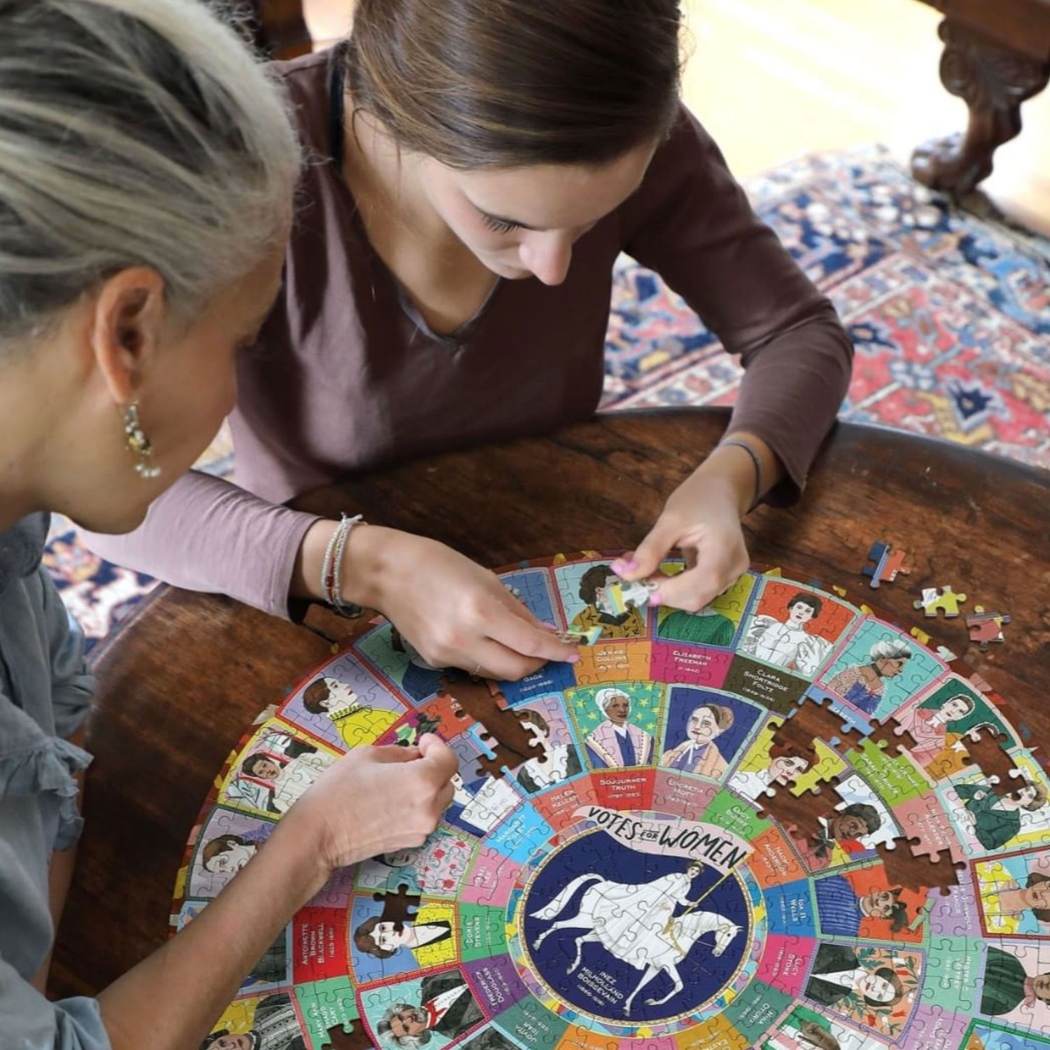 Two women completing our Votes for Women 500 piece puzzle